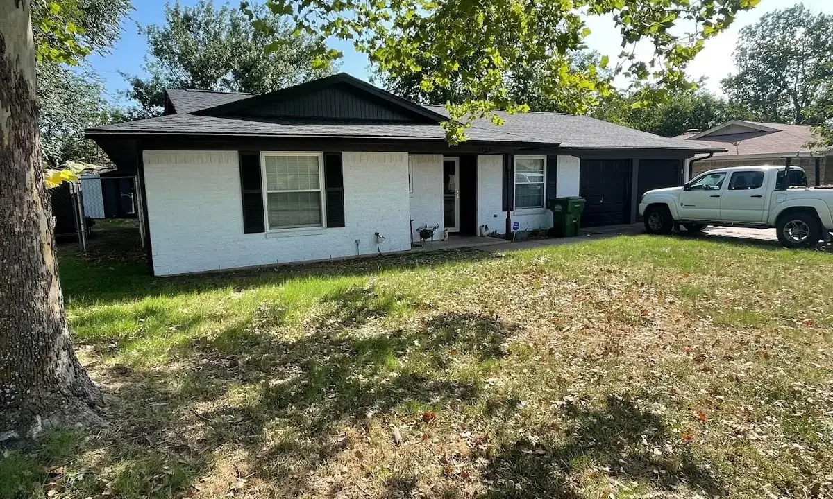 Professional roofing crew working on a residential roof in Pikesville